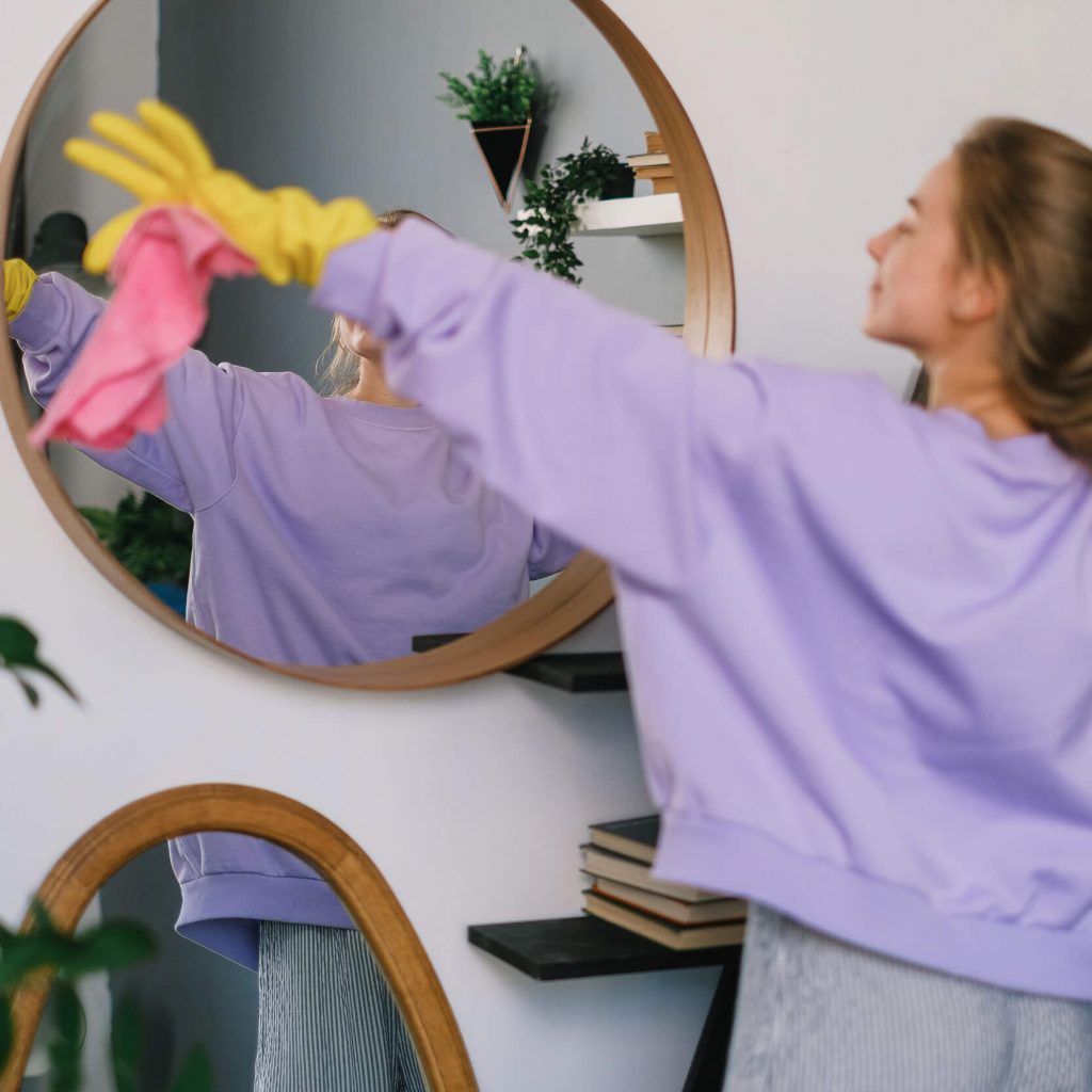 Woman Cleaning a Mirror